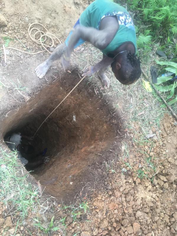 Digging new holes for toilets for the Bible School